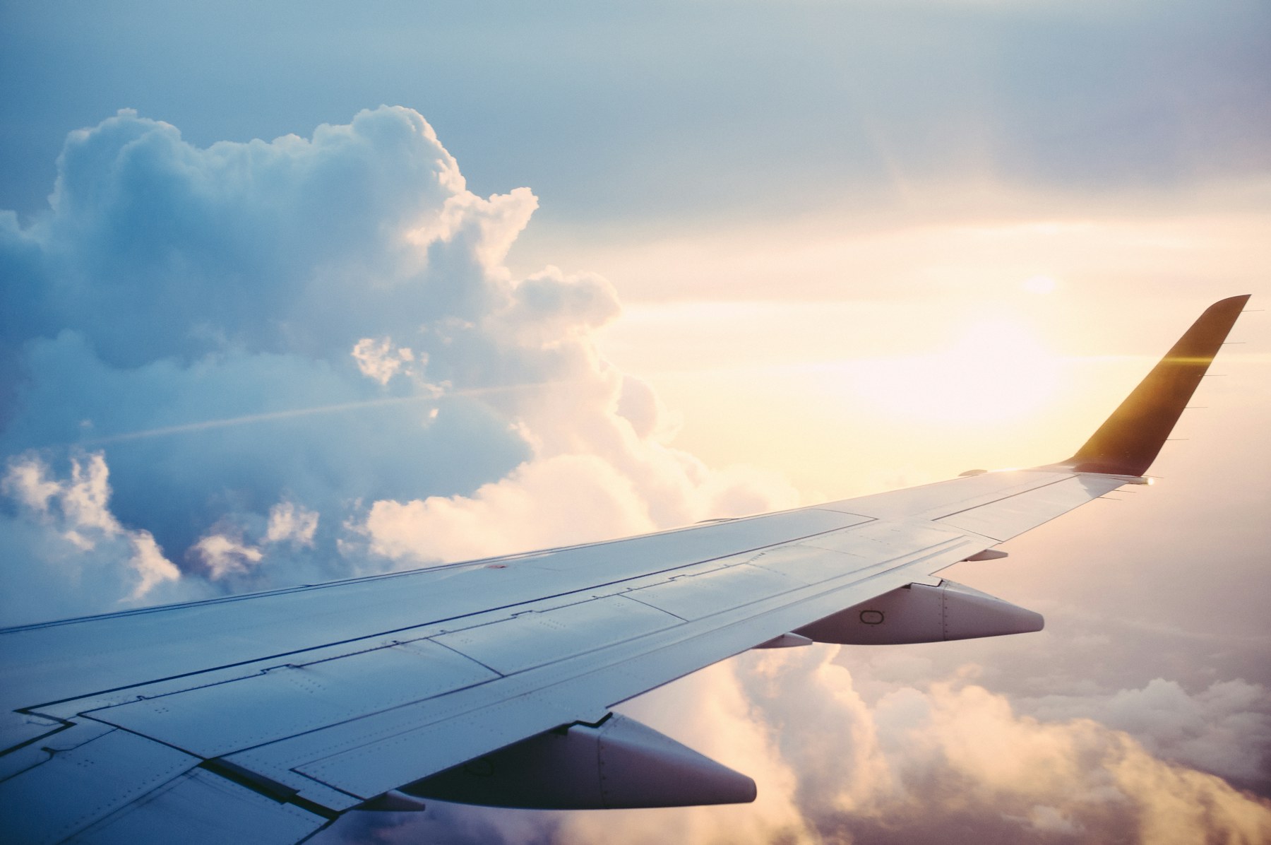 View of an airplane wing above the clouds